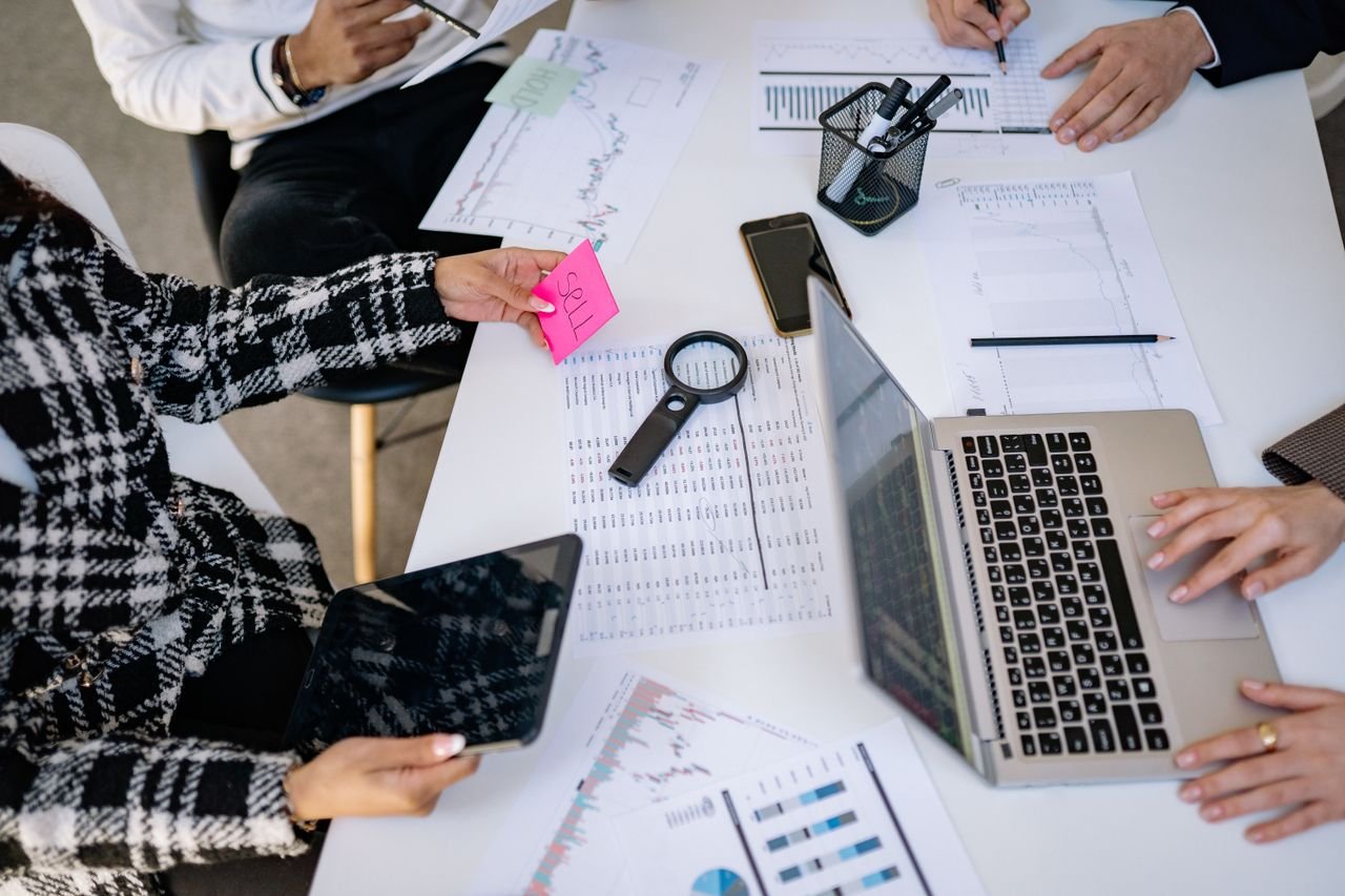 Business professionals collaborating on financial data analysis in a modern office setting.